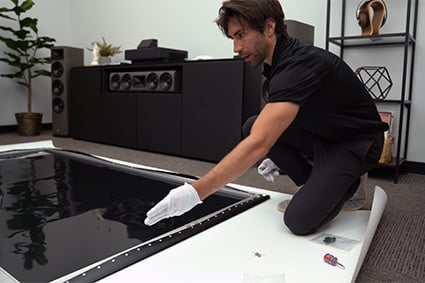 Audio Advice home theater installer assembling the screen that comes with the EPSON LS500 UST 4K projector.