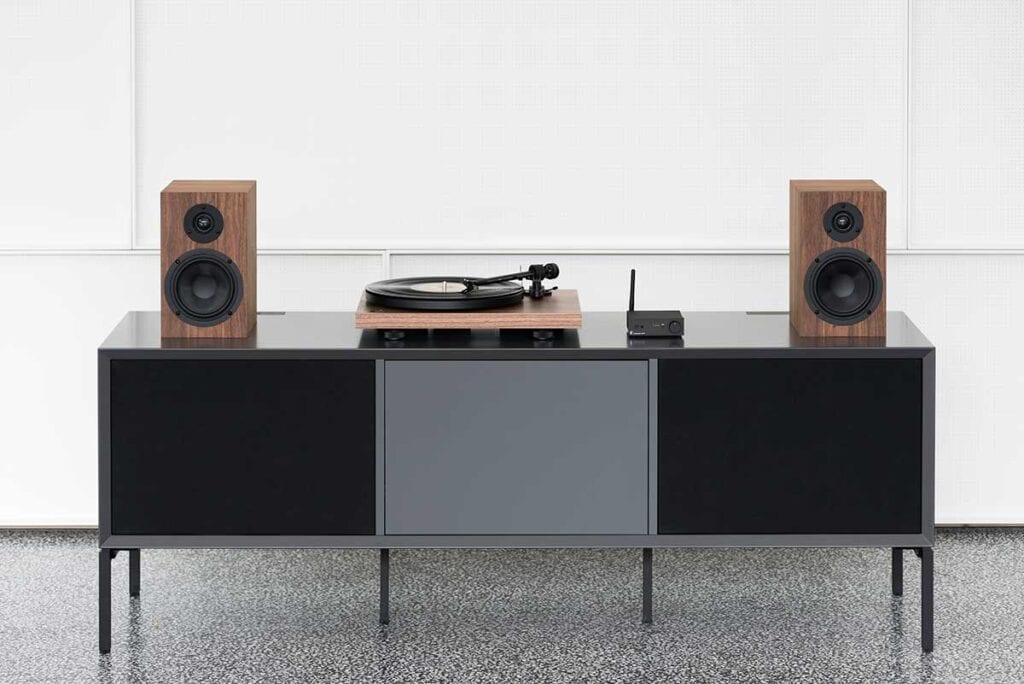 Pro-Ject turntable and speakers on top of a black console desktop