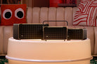 JBL Authentics Speakers on a round table in front of a couch