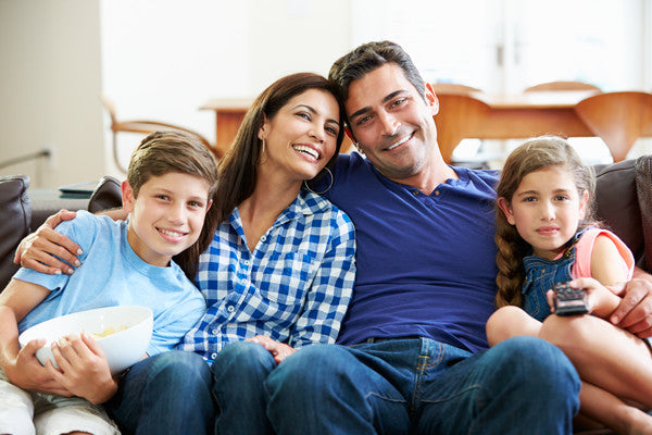 Family of four watching television