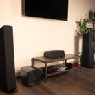 GoldenEar ForceField 30 - 8” Compact Subwoofer - Black - sitting on floor next to entertainment console