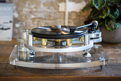 Michell Gyro SE Turntable in silver on a clear platform on a cabinet