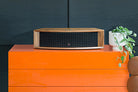 JBL L75ms Music System in walnut on an orange shelf