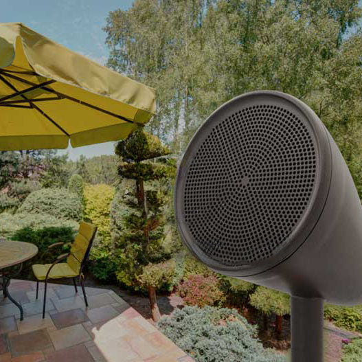 An outdoor speaker beside a patio