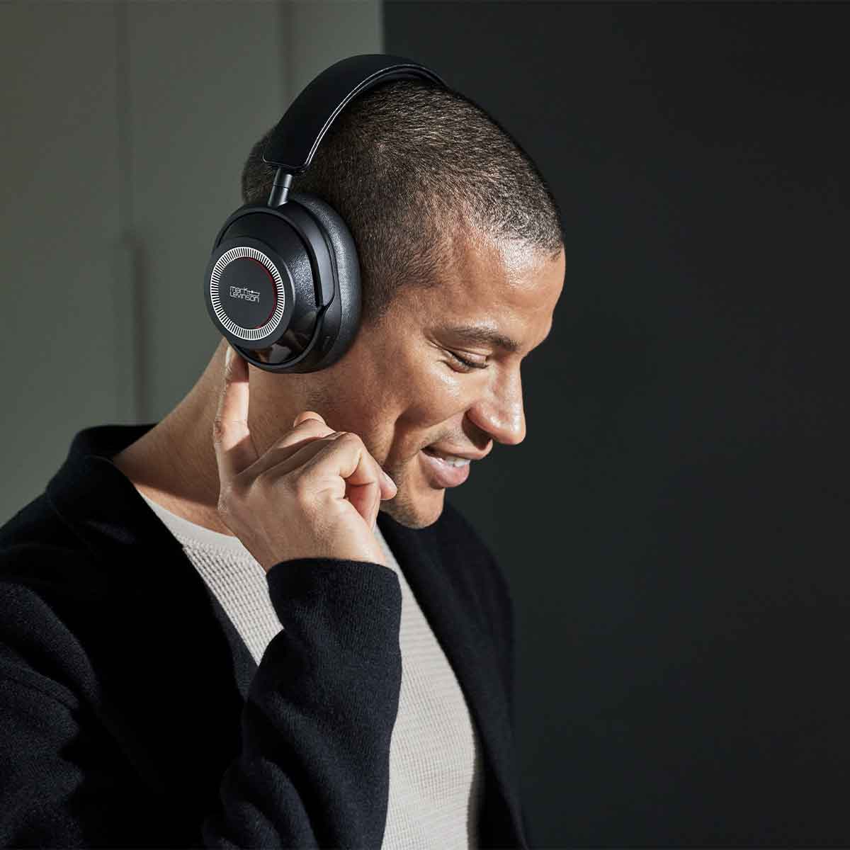 Male model wearing a pair of Mark Levinson № 5909 Premium Hi-Res Wireless ANC Over-Ear headphones in the black finish.