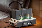 McIntosh MHA200 Headphone Amp with headphones on table