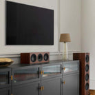 KEF Q250C Center Channel Speaker - Walnut - alternate angled view on entertainment stand under TV