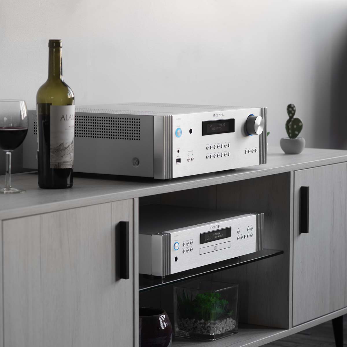 Rotel RA-6000 Integrated Amplifier - Silver - angled front view on media cabinet with matching DT-6000 DAC/CD transport