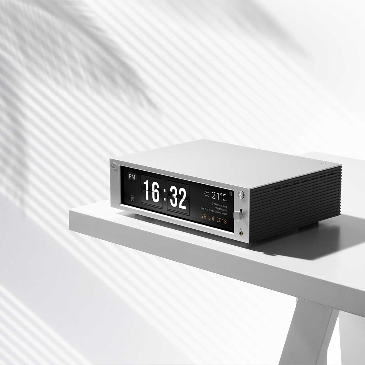 Side angled view of the HiFi Rose RS201E Integrated Amplifier and Network Streamer sitting on top of a tabletop.