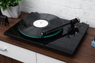 Pro-Ject T2 Turntable in Piano Black on a wooden console table