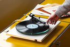 Pro-Ject T2 Turntable in Gloss White on a yellow table