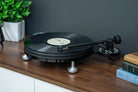 Michell Tecnodec Turntable with a record on a console cabinet