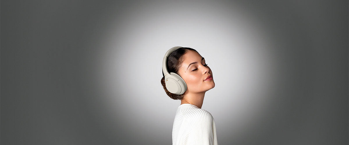 a woman listening enjoying music with a pair of Sony WH-1000SM4