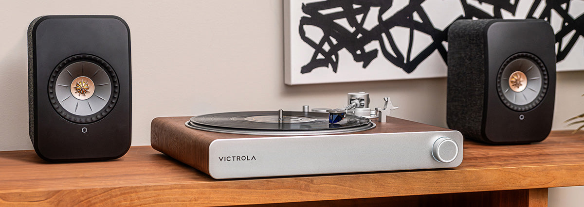 Victrola Sapphire Turntable on a shelf between speakers